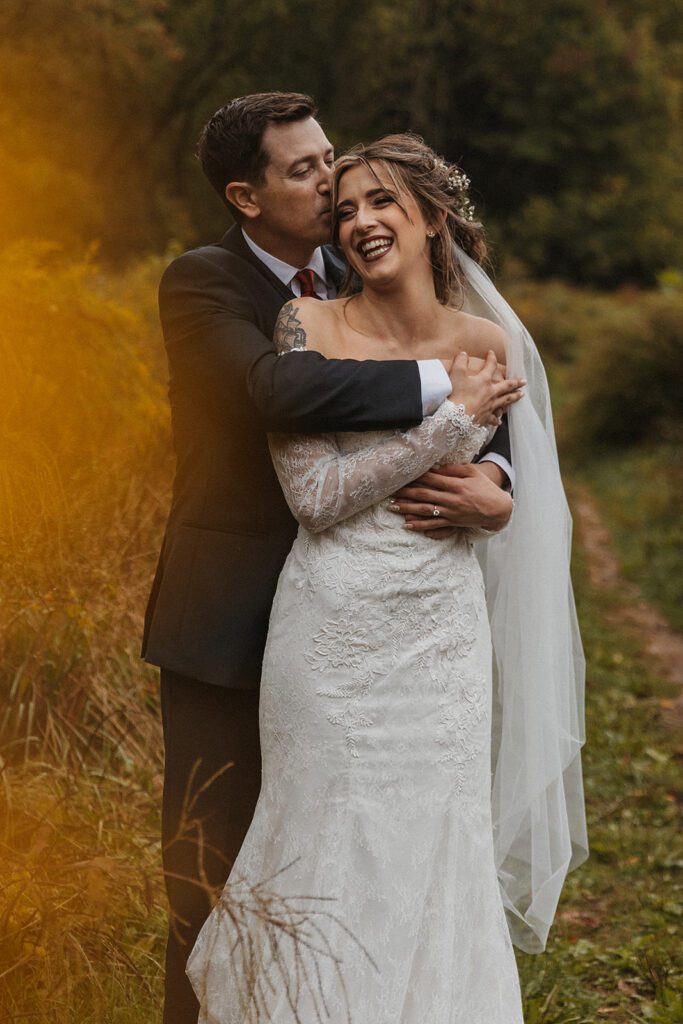 A beautiful bohemian wedding photo, bride and groom hugging each other