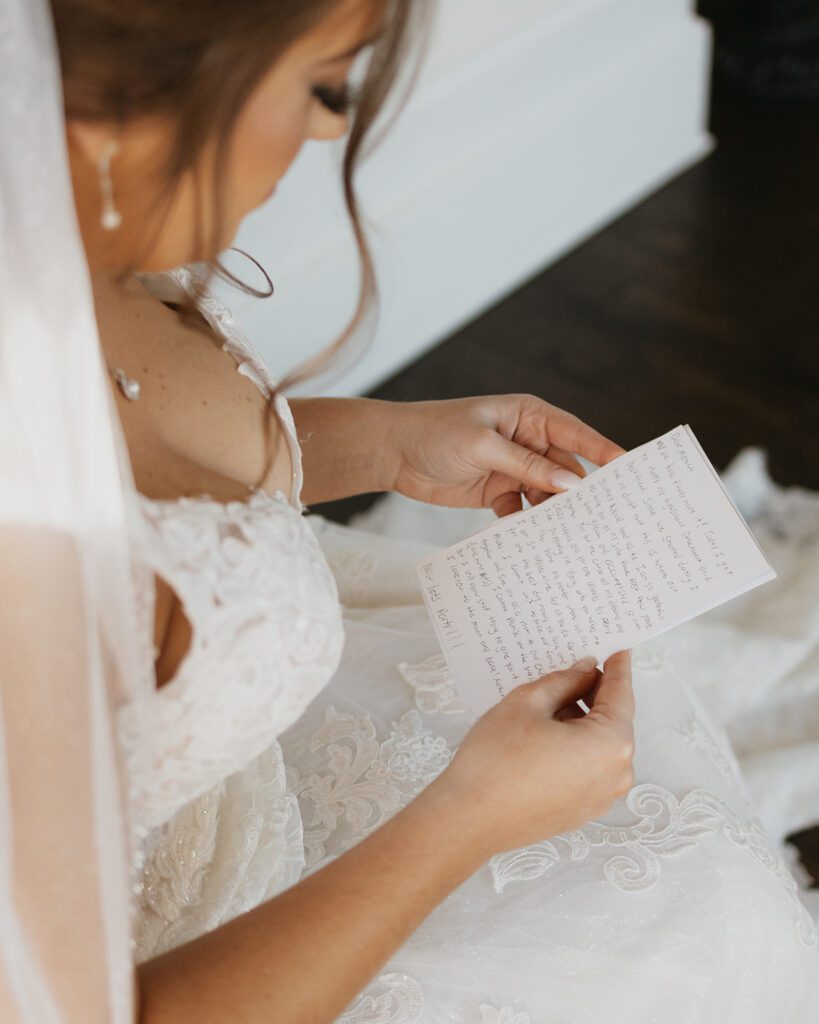Bride reading a letter from the groom ahead of the first look