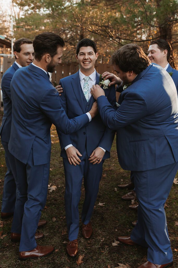 Fun groom and groomsmen photo, dark blue tuxedos
