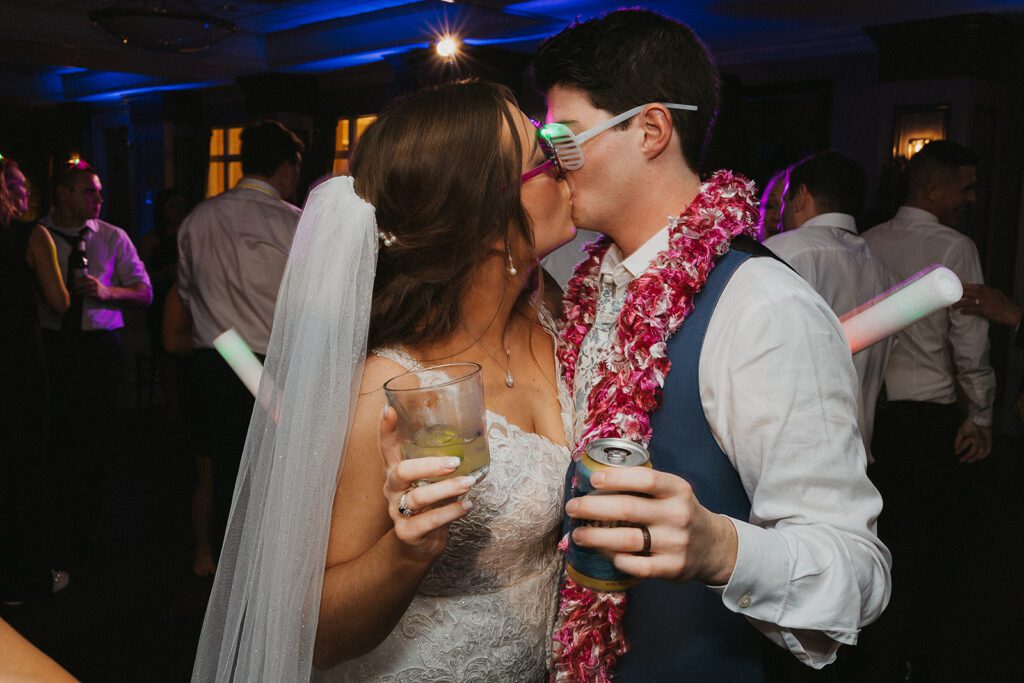 Bride and groom kiss during the reception party