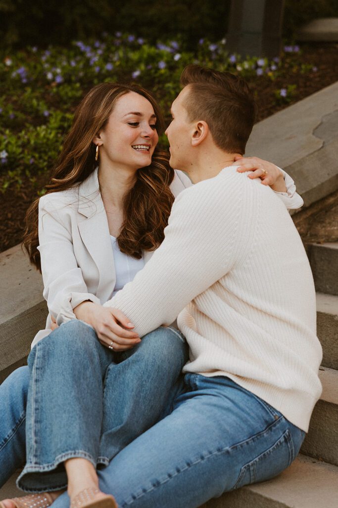 A couple posing on the stairs for their engagement photos