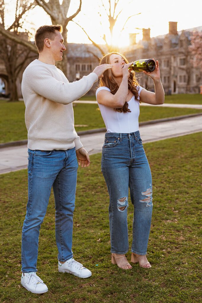 A couple drinking champagne from the bottle