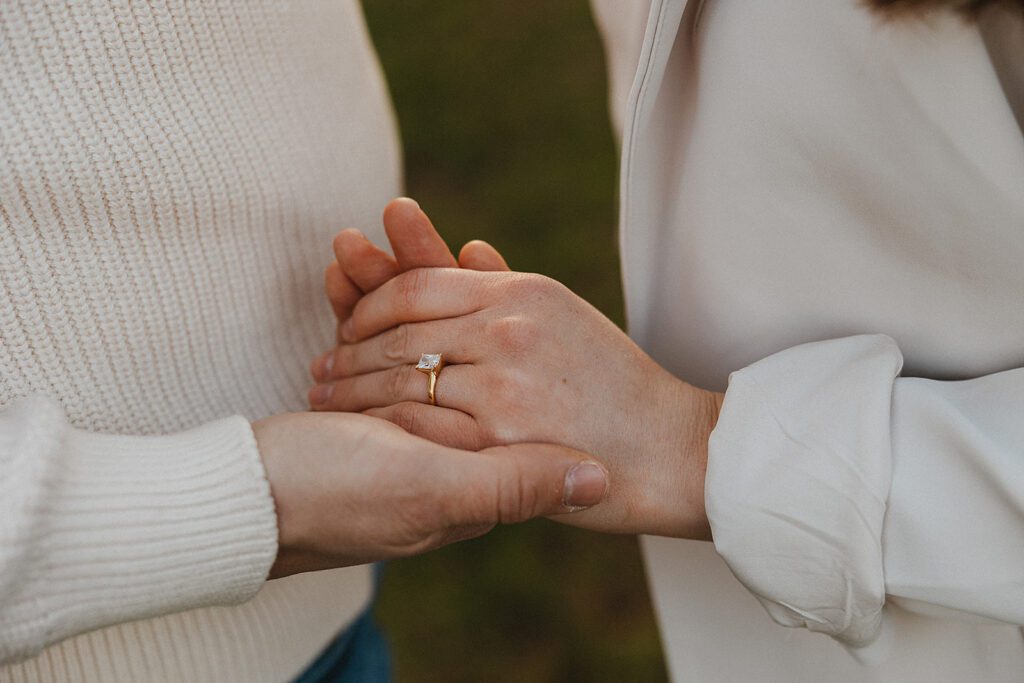 A close up of engagement ring, couple holding hands, Princeton University engagement photo