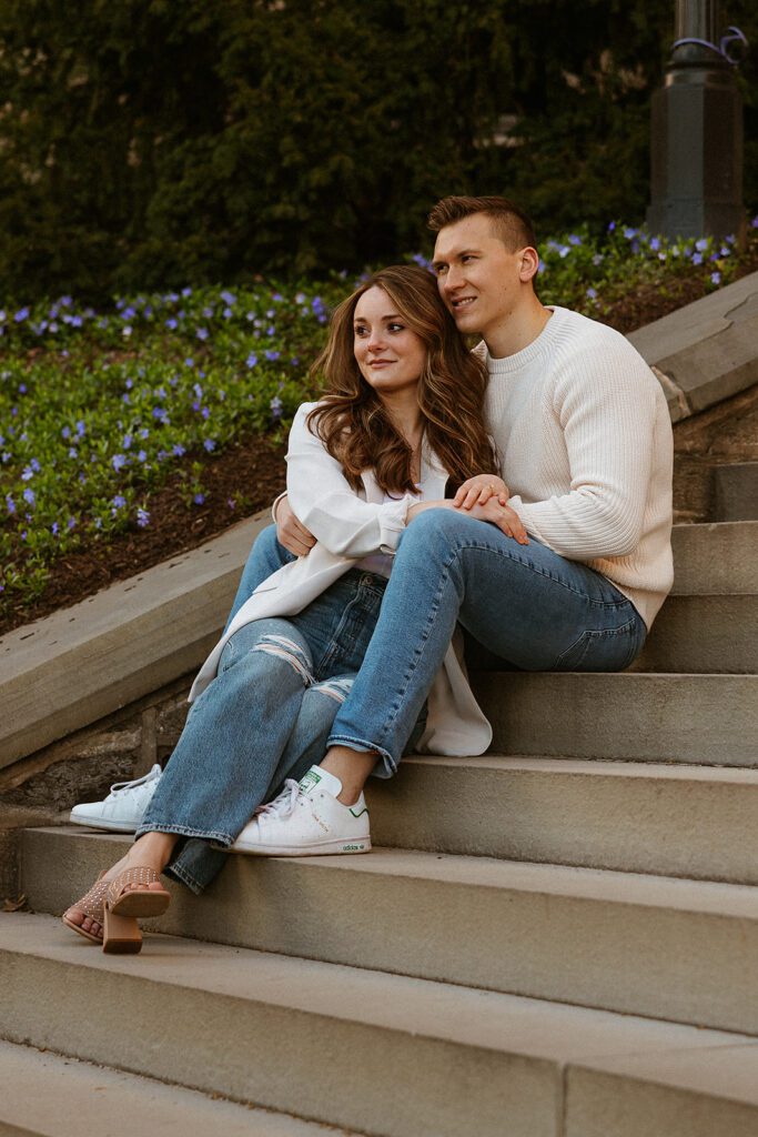 A couple posing on the stairs for their engagement photos