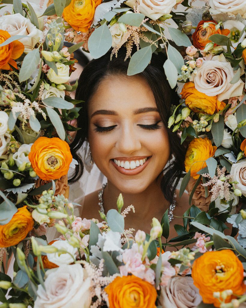 Beautiful bridal portrait of bride surrounded by flowers
