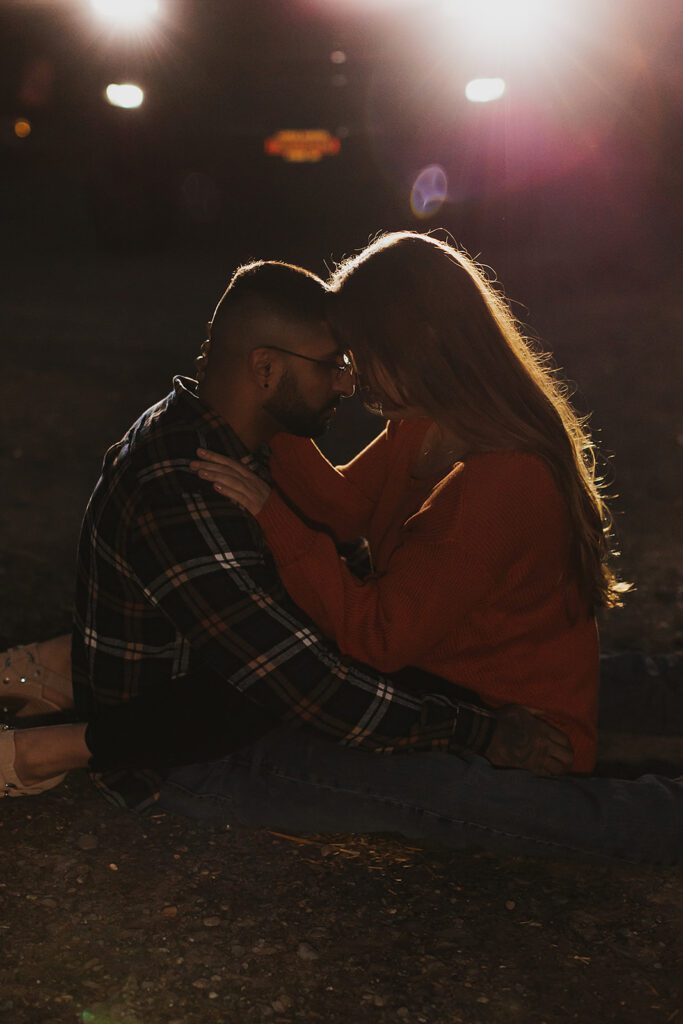 candid nighttime engagement photos with car headlights