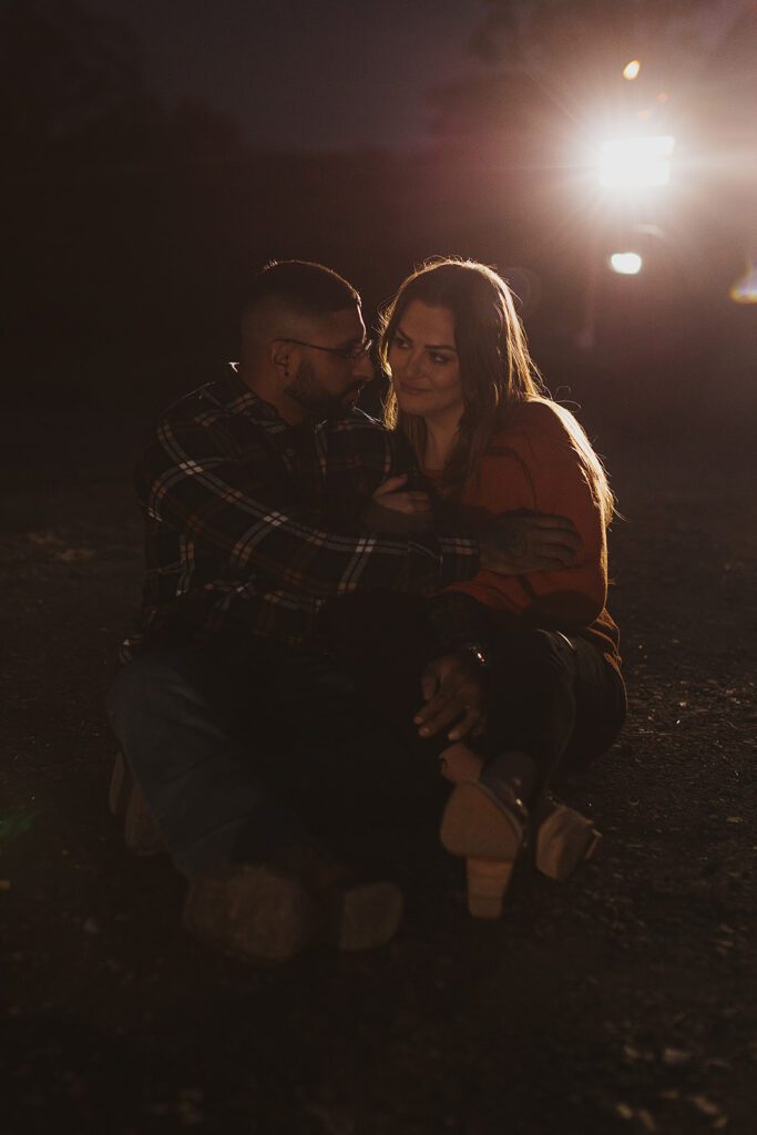 candid nighttime engagement photos with car headlights