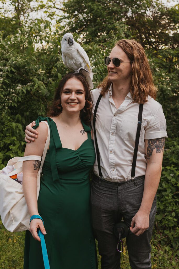 Playful engagement photos of the couple with a cute parrot