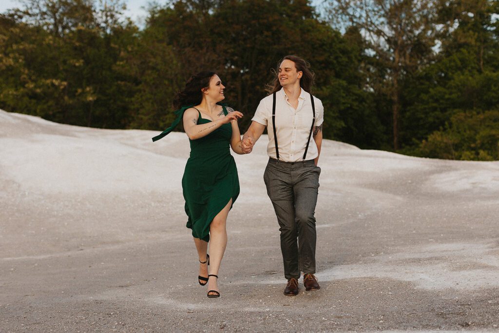Playful engagement photo of the couple running