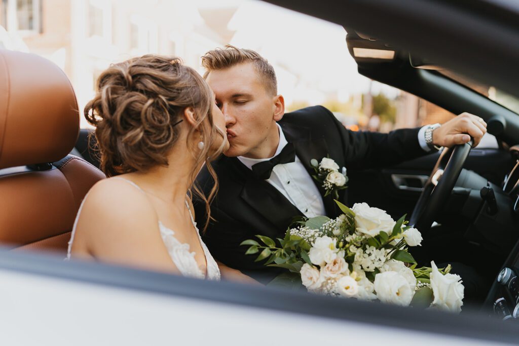 Bride and groom in a convertible