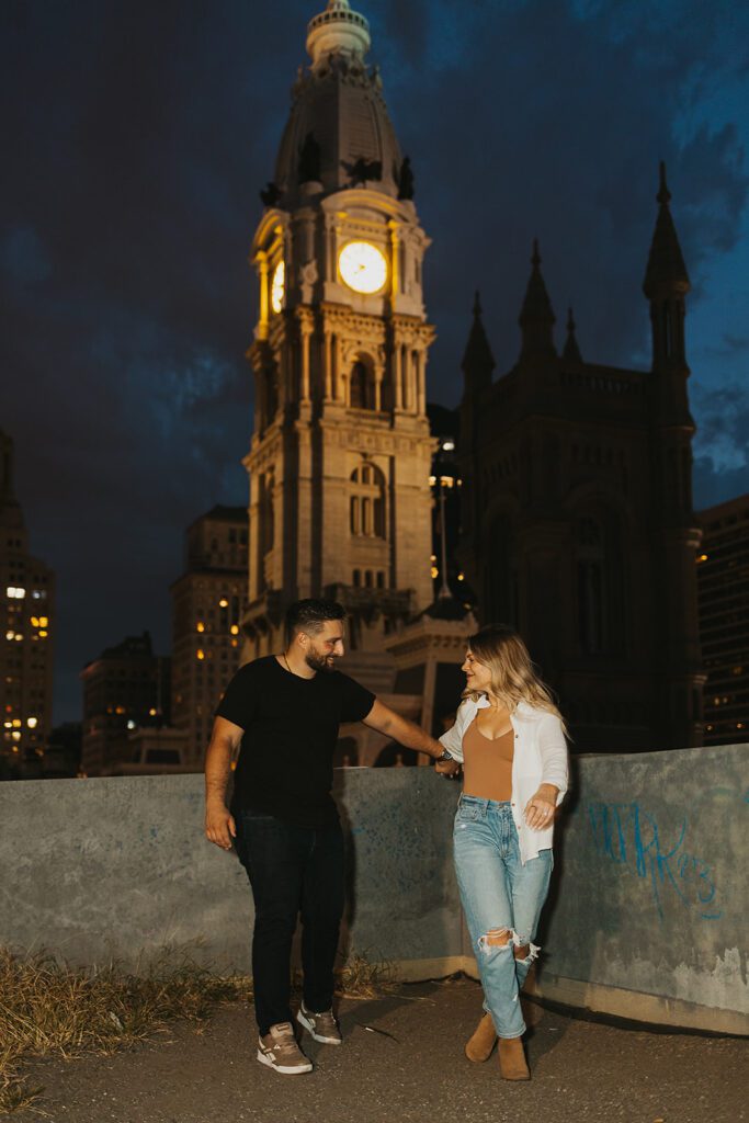 romantic nighttime city engagement photo on a rooftop in Philly