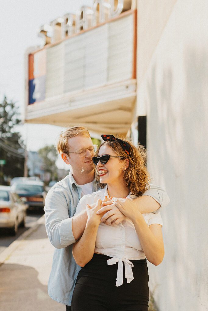 50s inspired engagement photo by a vintage movie theatre