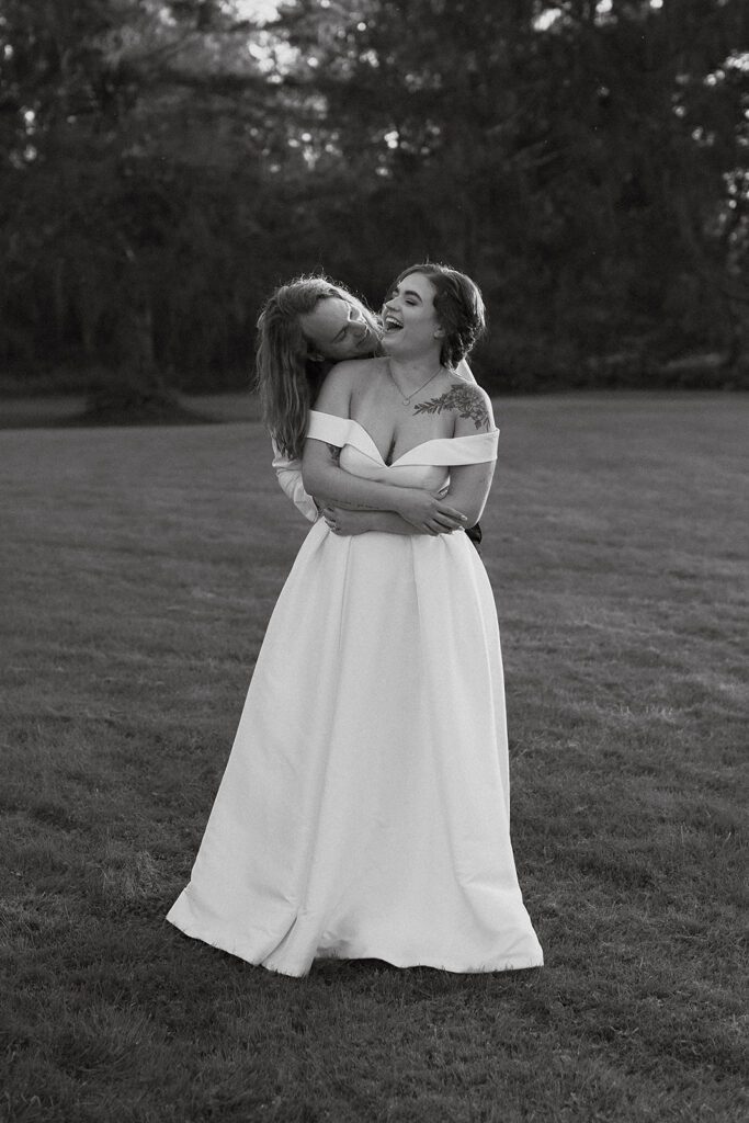 black and white bride and groom photo in a field at an upstate new york wedding venue