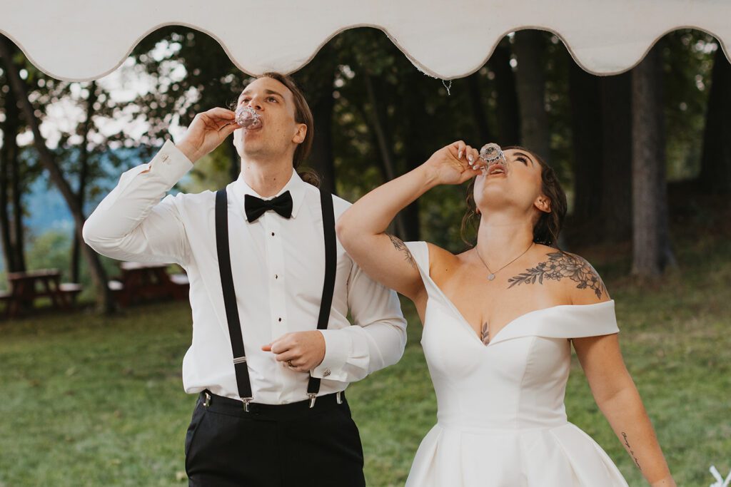 bride and groom taking shots at the reception