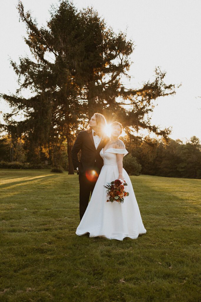 bride and groom golden hour photo in a field at an upstate new york wedding venue