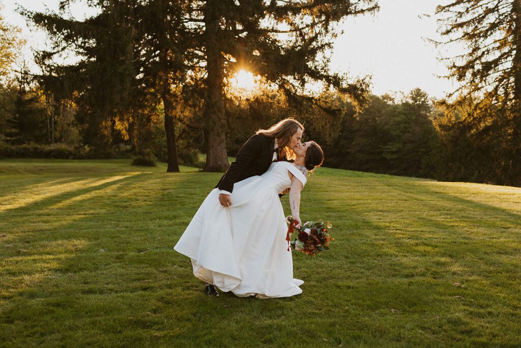 bride and groom golden hour photo in a field at an upstate new york wedding venue