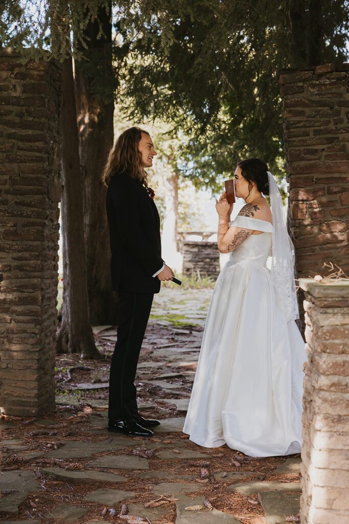 bride and groom first look in ancient ruins at an upstate new york wedding venue