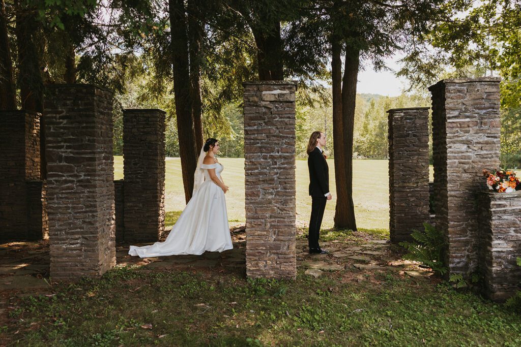 bride and groom first look in ancient ruins at an upstate new york wedding venue