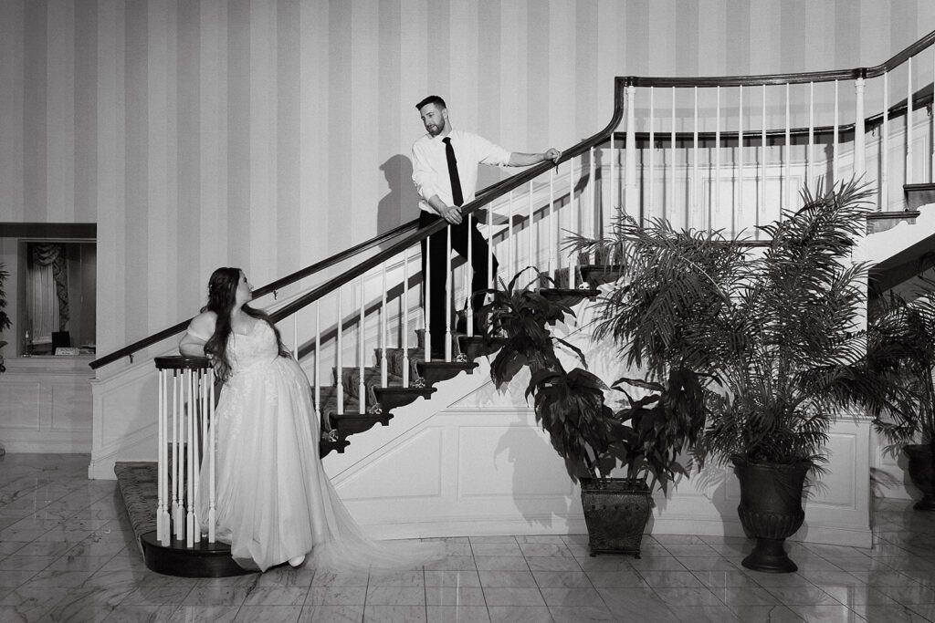 Indoor bride and groom portrait in the country club's elegant lobby on the stairs