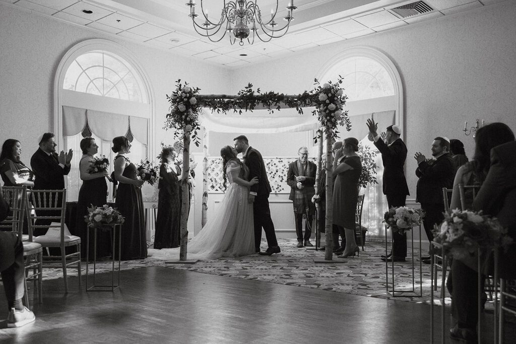 Intimate moment during a Jewish wedding ceremony, held at a picturesque country club venue