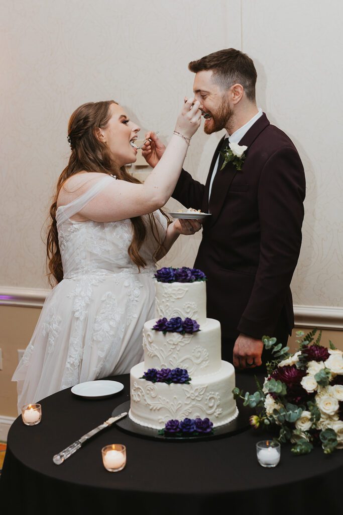 Newlyweds cutting the wedding cake together
