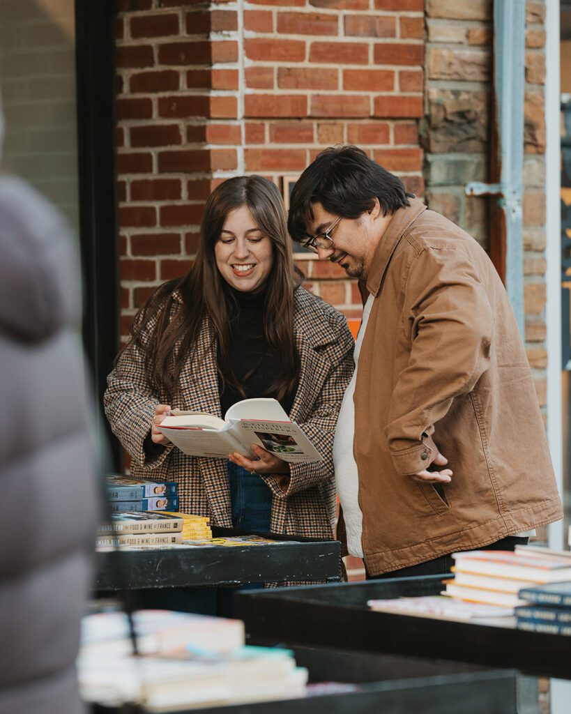 Alexa and Joe checking out some books  as they came across a book fair in the streets of Palmer Square