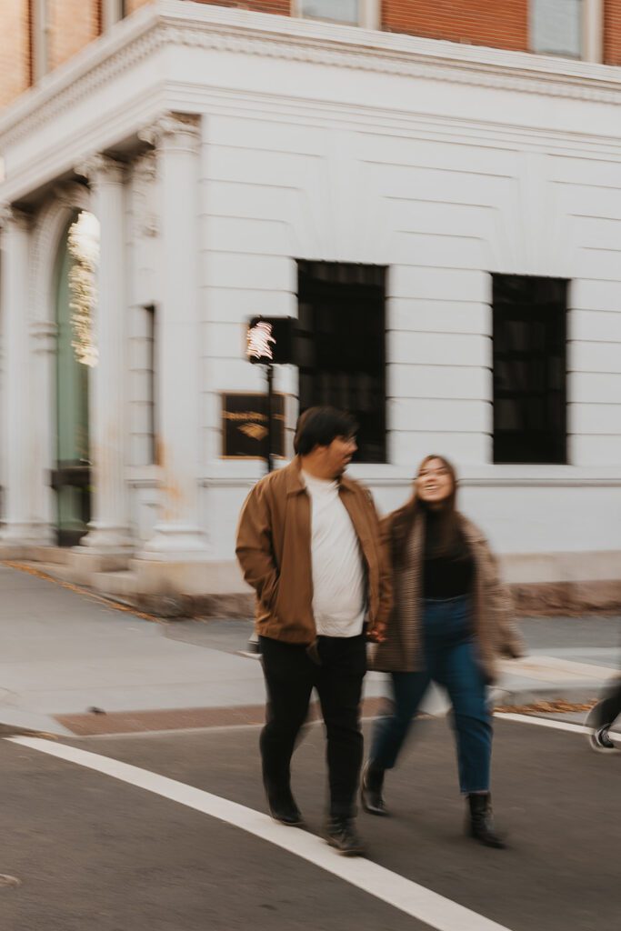Cinematic long range shots of a couple roaming the streets during their downtown engagement session