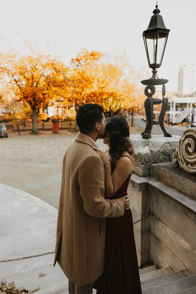The couple enjoying a romantic moment outside the Merchants Exchange, surrounded by the beauty of Philadelphia's history