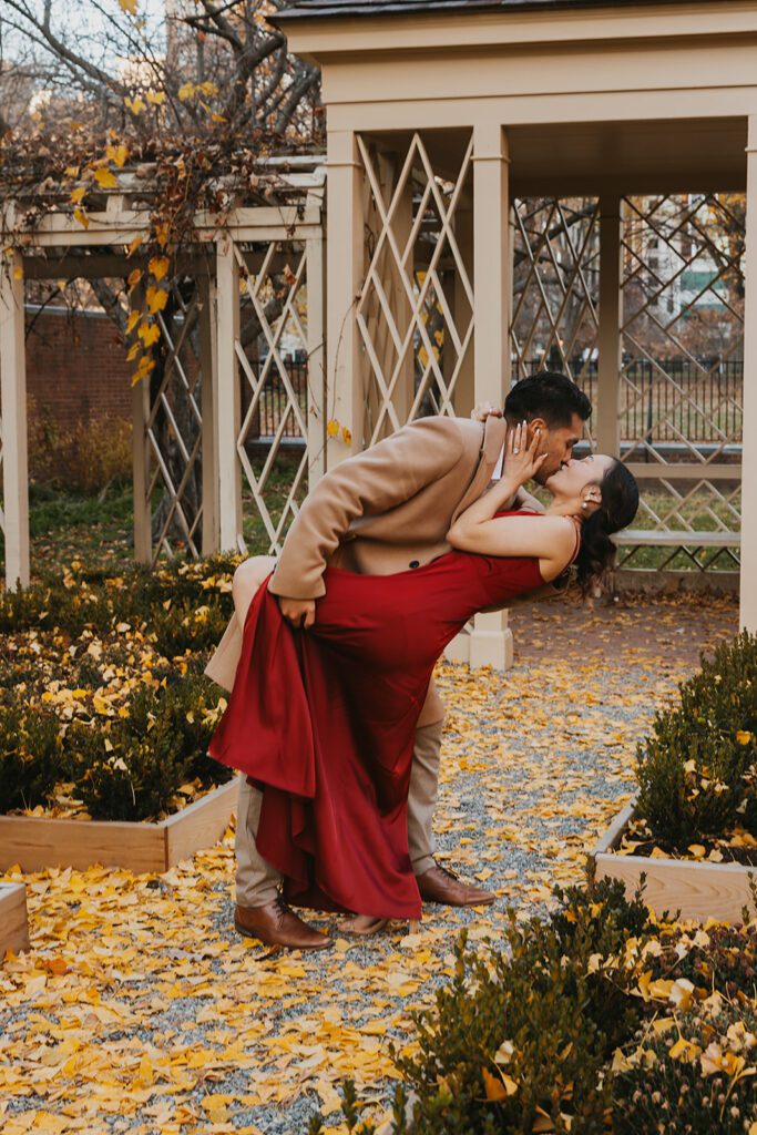Megan and Luis romantic engagement photos in front of a cozy park gazebo