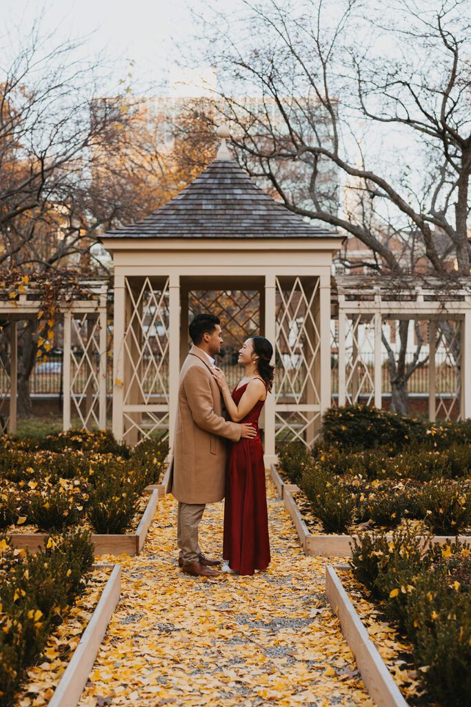 Megan and Luis romantic engagement photos in front of a cozy park gazebo