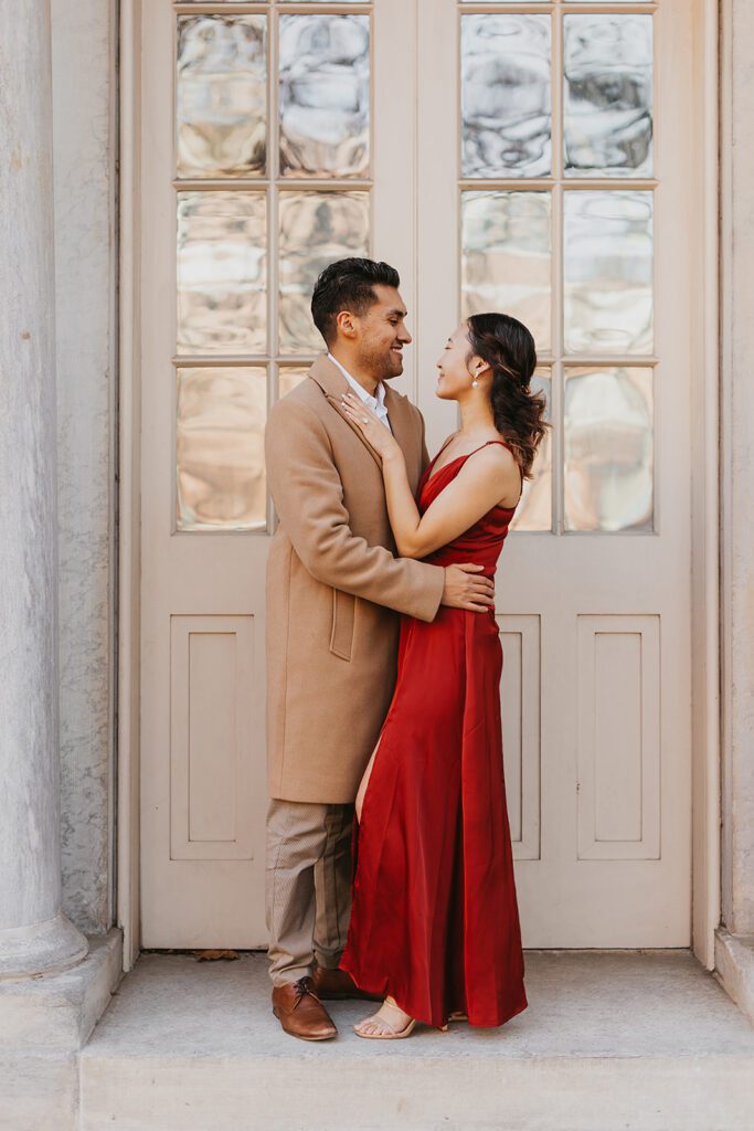 Megan and Luis holding hands and walking around for their Old City Philadelphia engagement photos