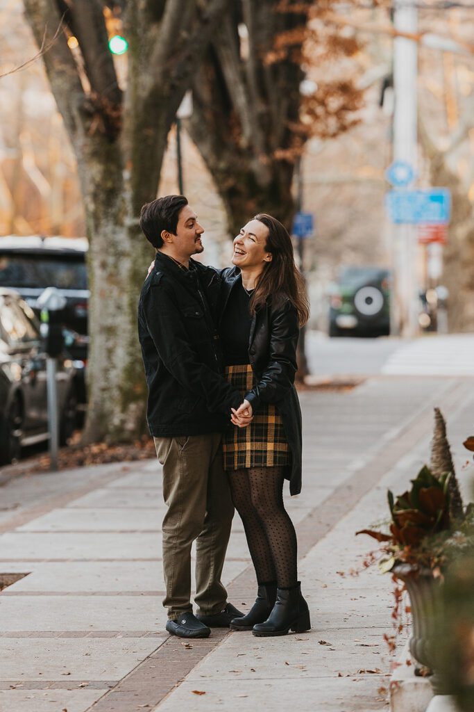 Engagement photo capturing Christine and Joe's playful spirit as they enjoy a moment together in the heart of downtown, embodying the essence of their urban engagement session