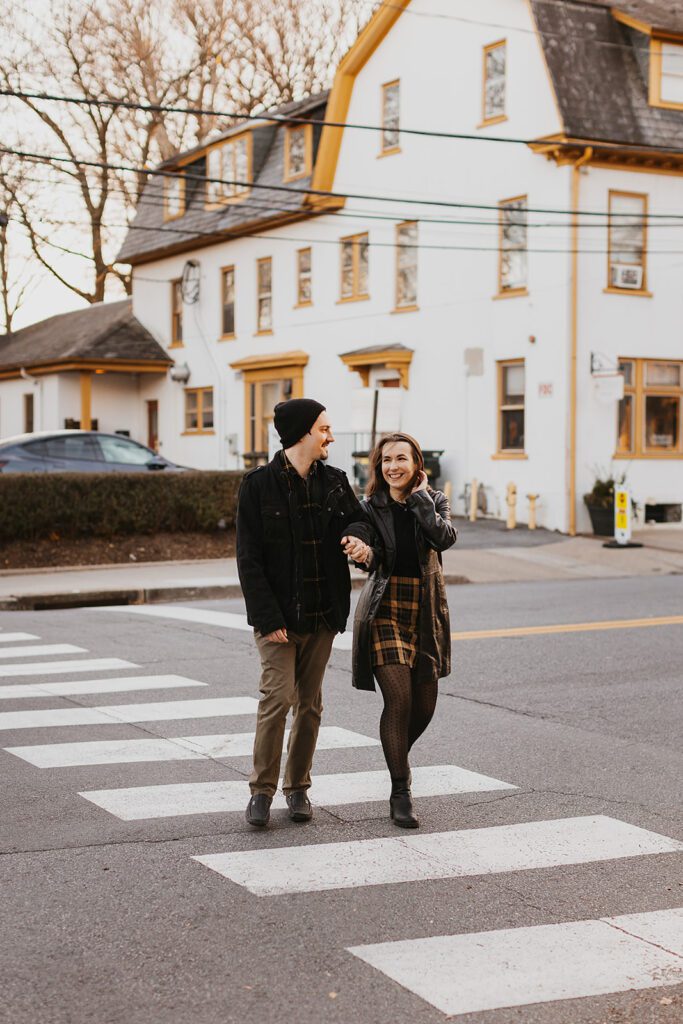 Christine and Joe strolling hand in hand through the vibrant streets downtown, their engagement photos radiating a casual and fun atmosphere