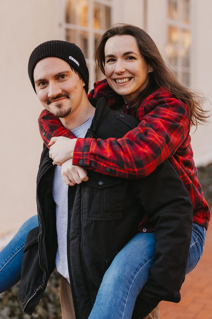 A playful and casual downtown engagement photo of Christine and Joe, with the bustling cityscape providing a lively backdrop.