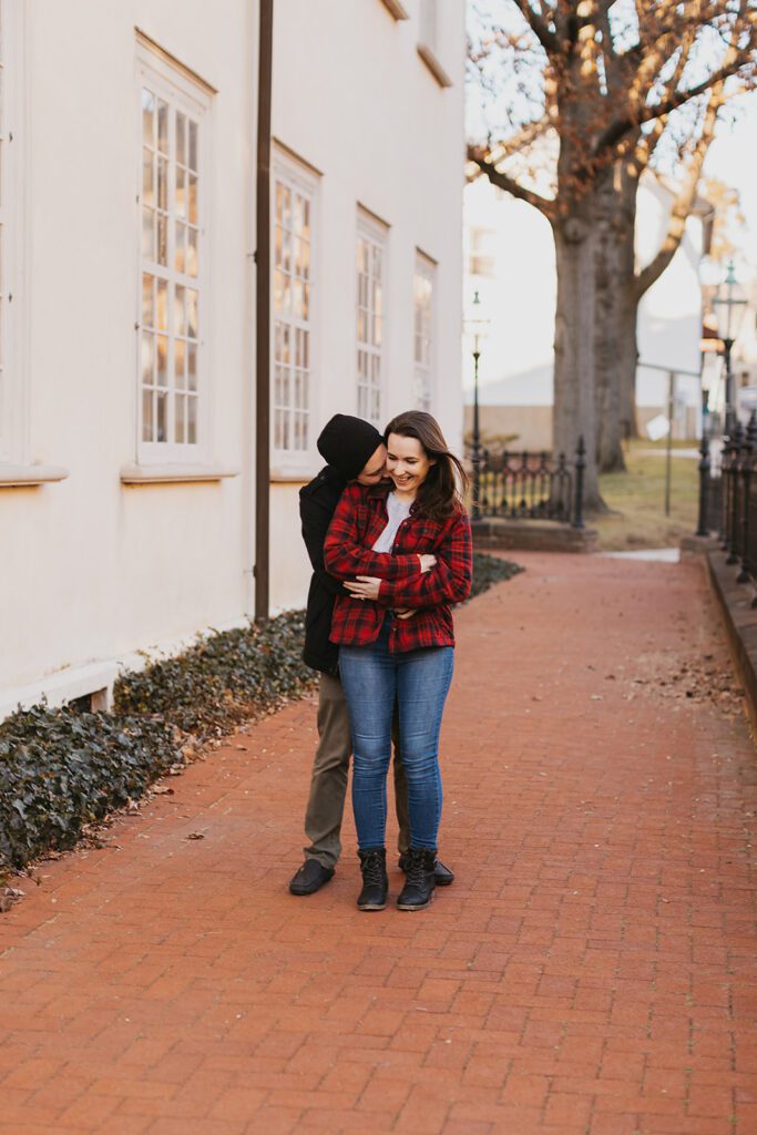 Christine and Joe strolling hand in hand through the vibrant streets downtown, their engagement photos radiating a casual and fun atmosphere.