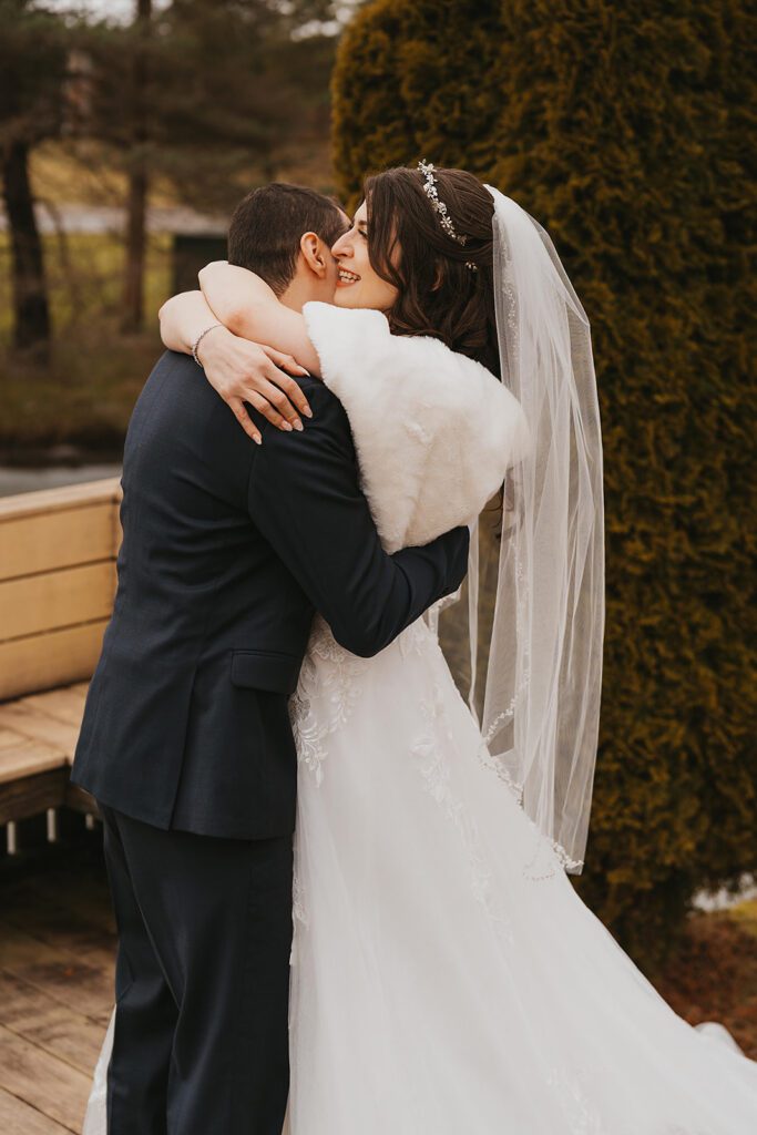 bride and groom first look outdoors during winter in the birch hill estates