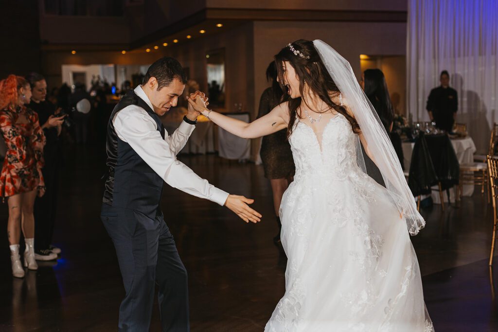 bride and groom having fun, dancing the night away during their wedding reception