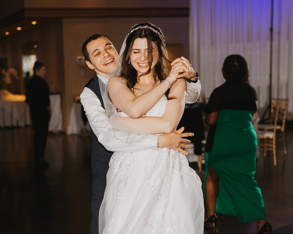 bride and groom having fun, dancing the night away during their wedding reception