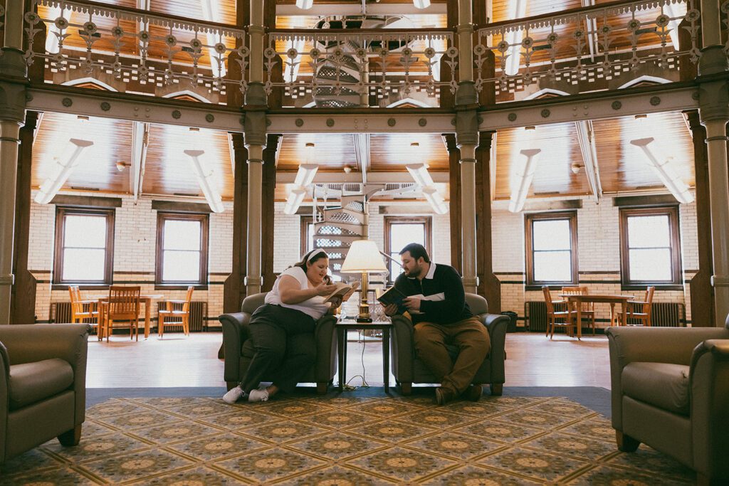 couple reading books together during their library engagement session at Lehigh University