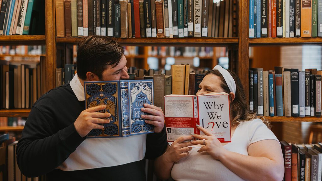 a couple browsing through books together for their library engagement photos