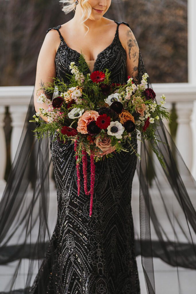bridal portraits with an alternative, gothic bouquet and black wedding dress
