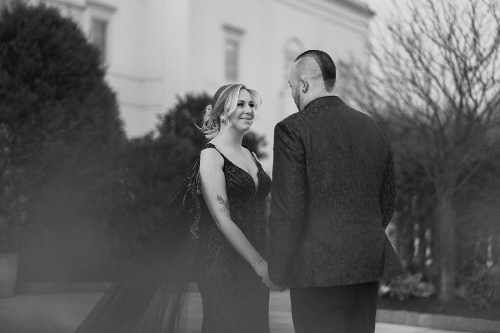 bride and groom emotional first look in front of the elegant Palace at Somerset Park