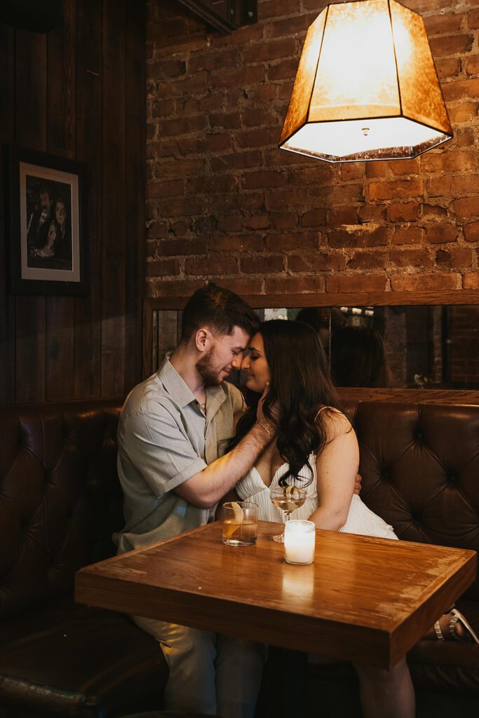 newly engaged couple enjoying drinks at a bar