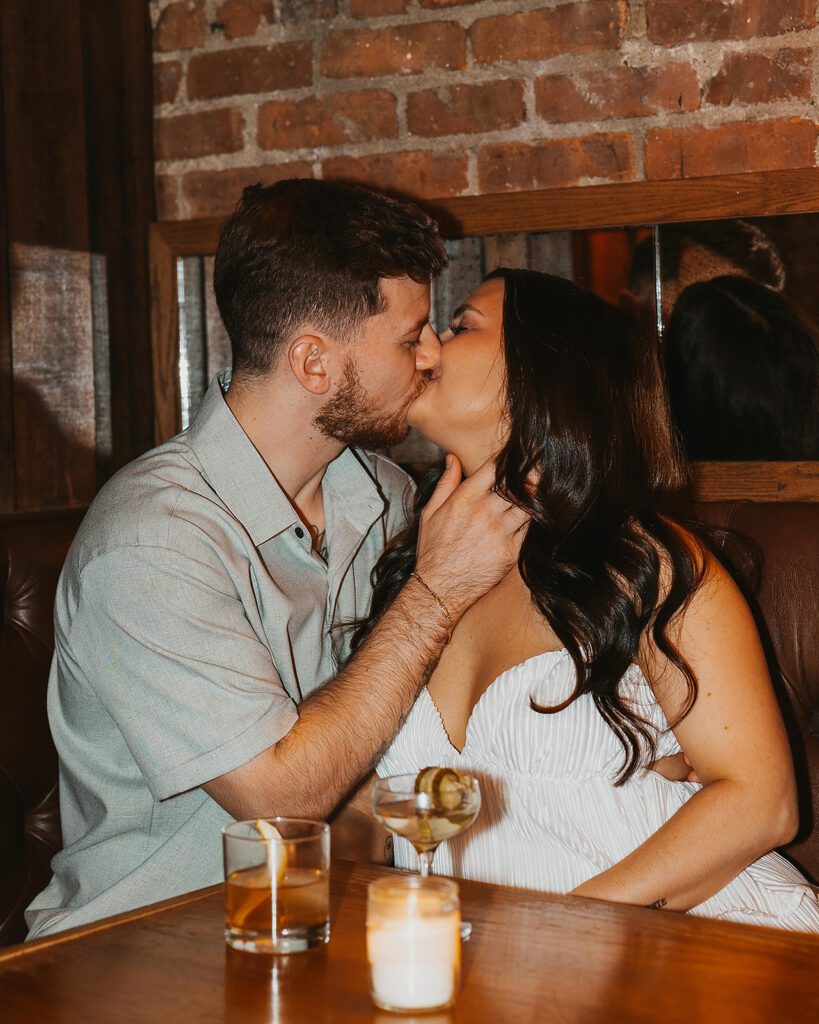 newly engaged couple enjoying drinks at a bar