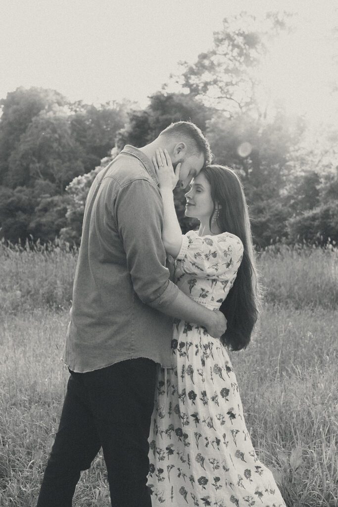 playful engaged couple in a field