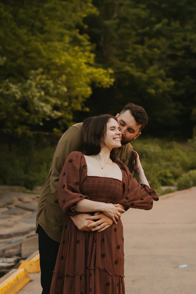 playful engaged couple in a field