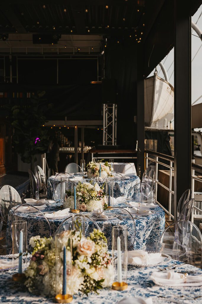 Blue and white floral arrangements, elegant place settings on Moshulu