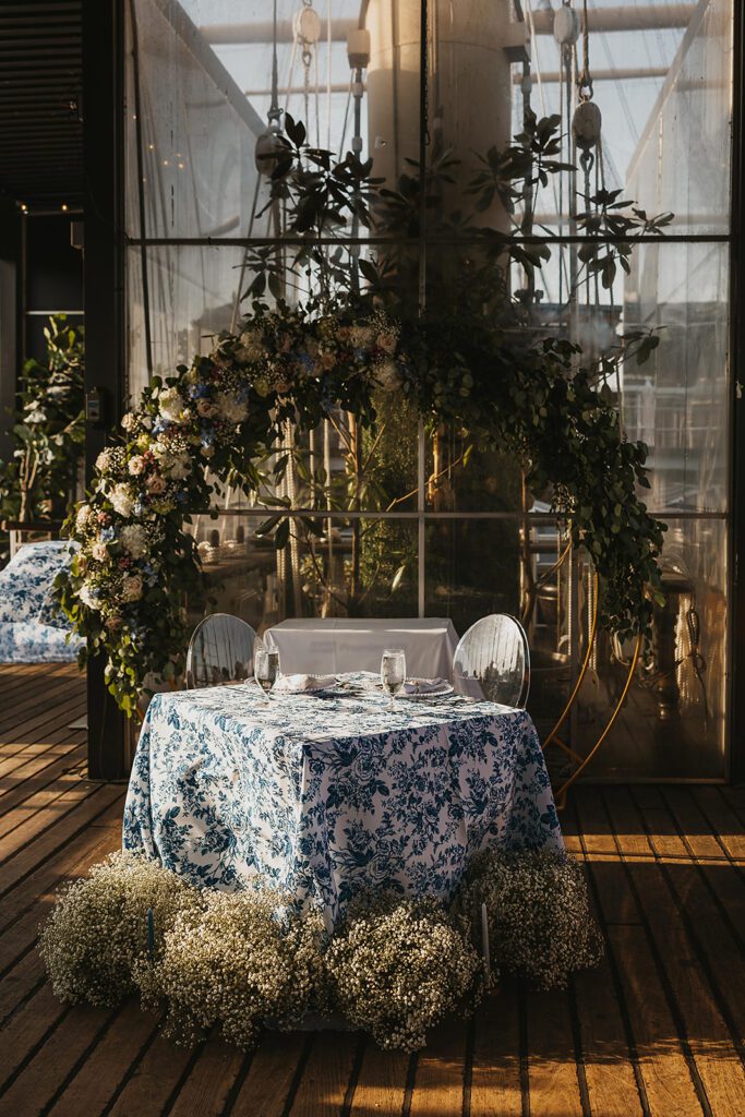 Blue and white floral arrangements, elegant place settings on Moshulu