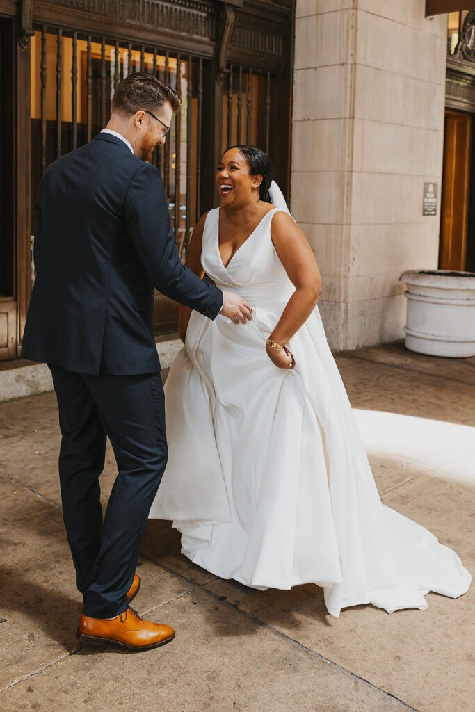 bride and groom first look in downtown Philadelphia surrounded by elegant architecture