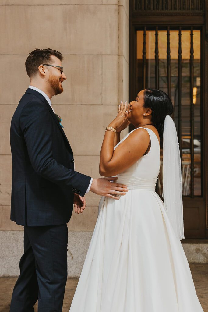 bride and groom first look in downtown Philadelphia surrounded by elegant architecture